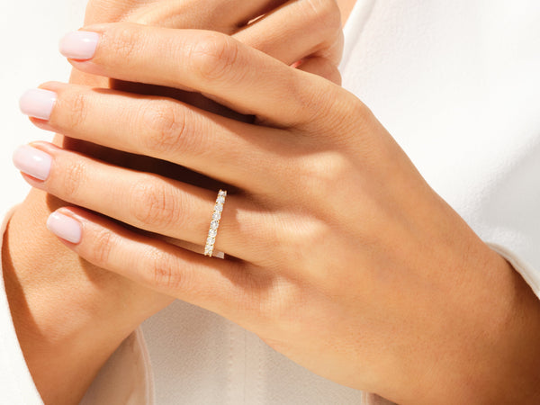 Diamond eternity ring on a woman's hand, jewelry product