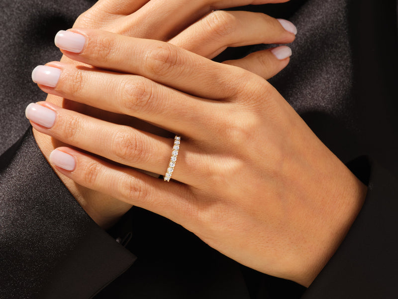 Diamond eternity ring on a woman's hand, fine jewelry