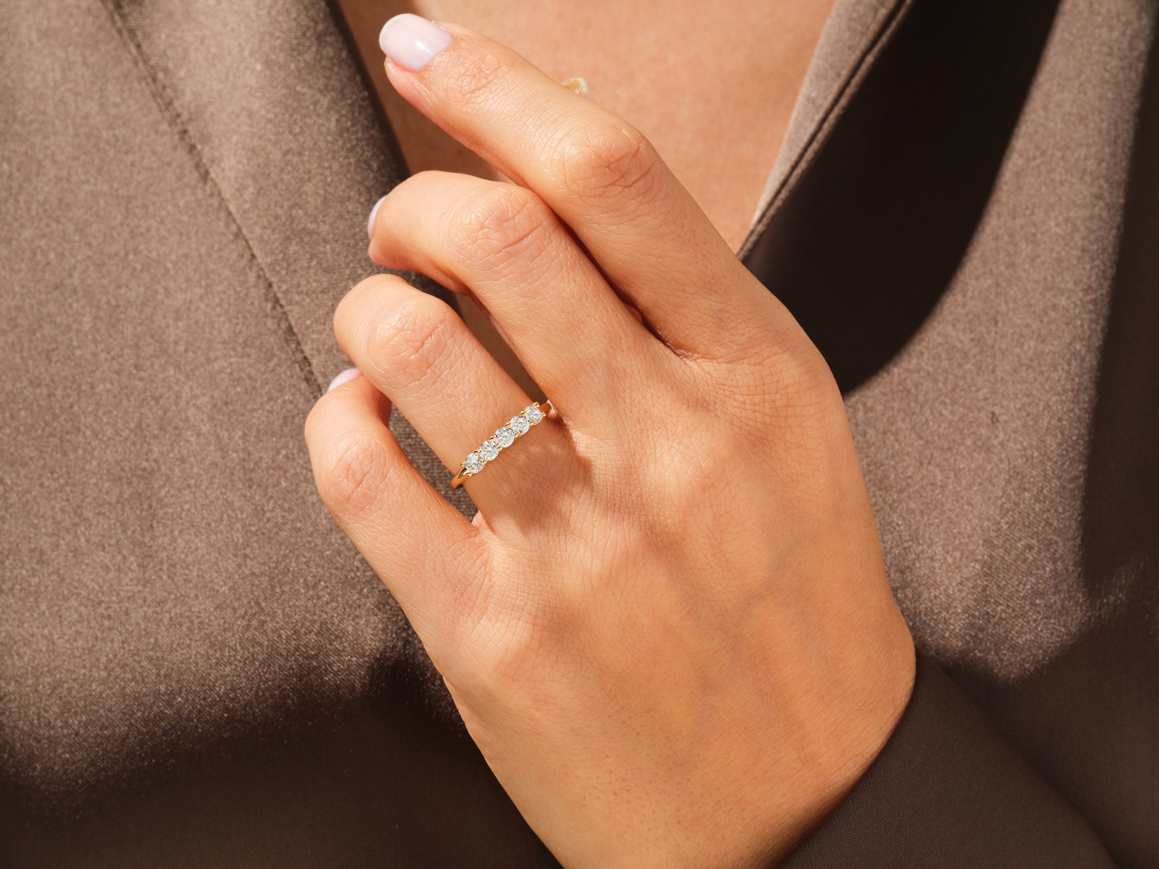 Diamond band ring on a hand, elegant jewelry for women