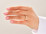 Diamond band ring on a woman's finger, jewelry photography