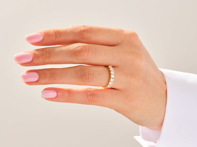 Diamond band ring on a woman's finger, jewelry photography