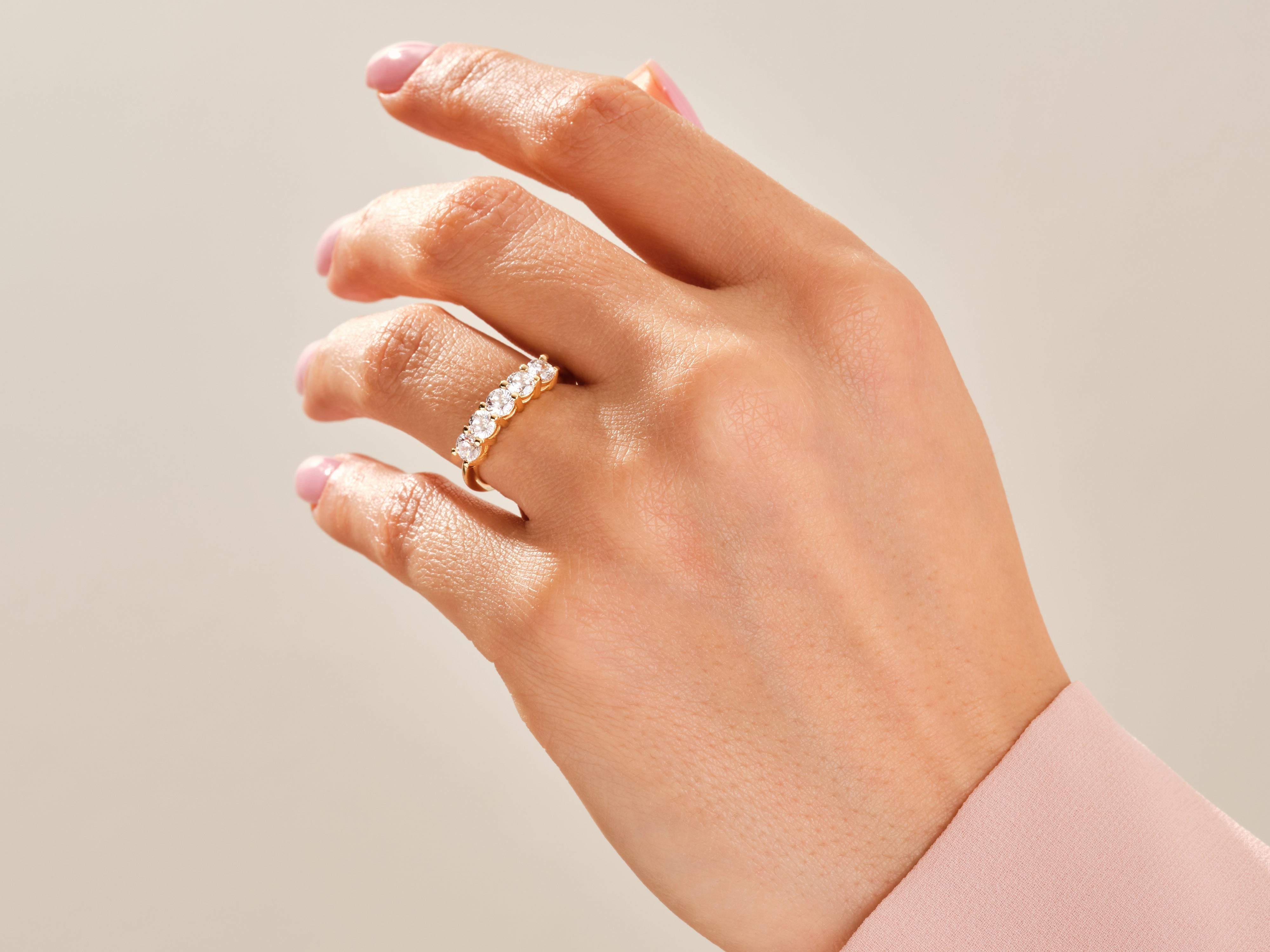 Gold diamond band ring on a woman's hand, jewelry