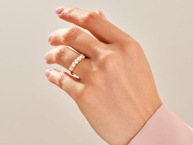 Gold diamond band ring on a woman's hand, jewelry