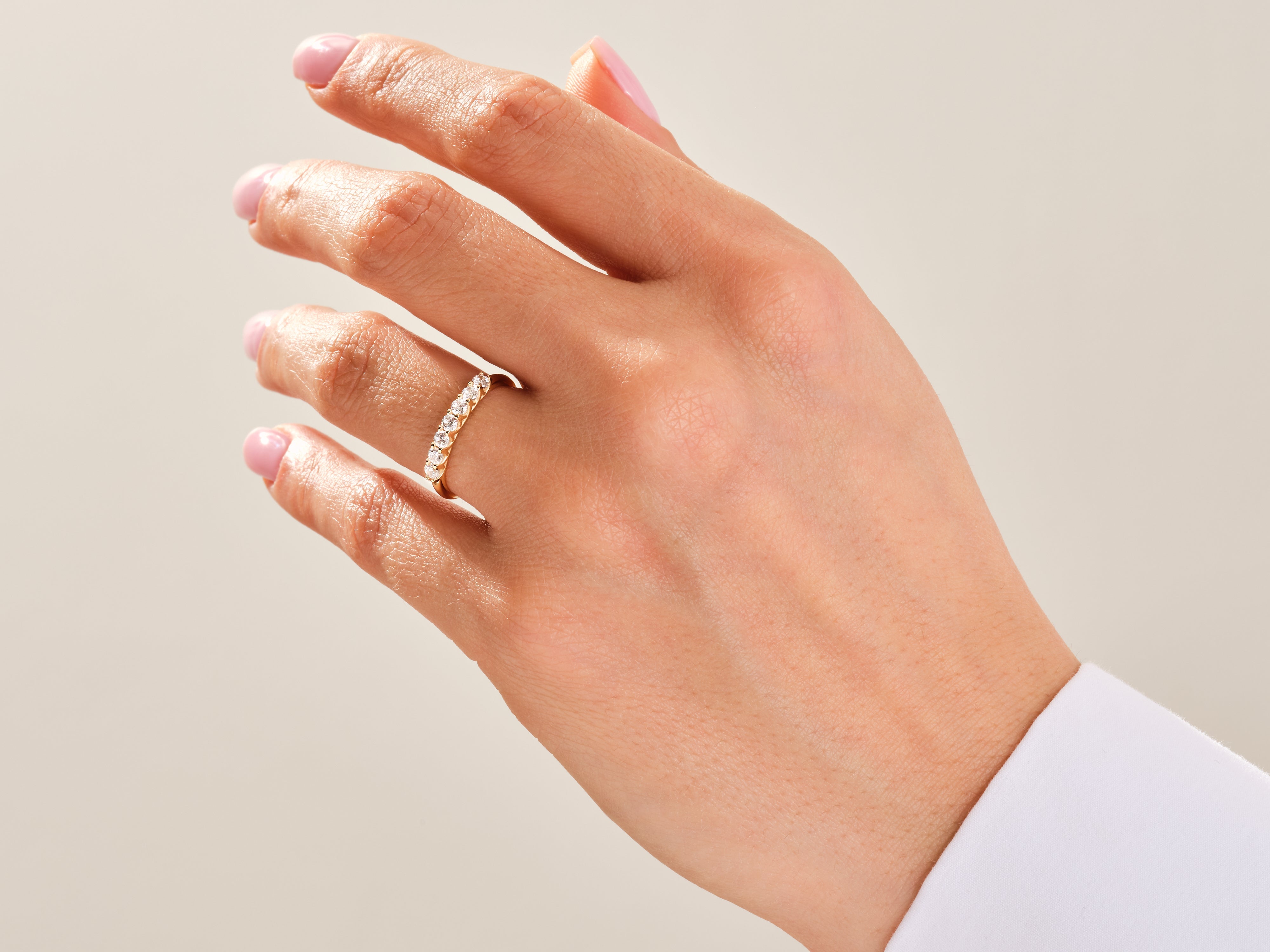 Diamond band ring on a woman's hand, fine jewelry