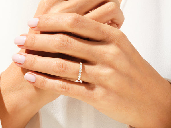 Diamond band ring on a woman's hand, fine jewelry