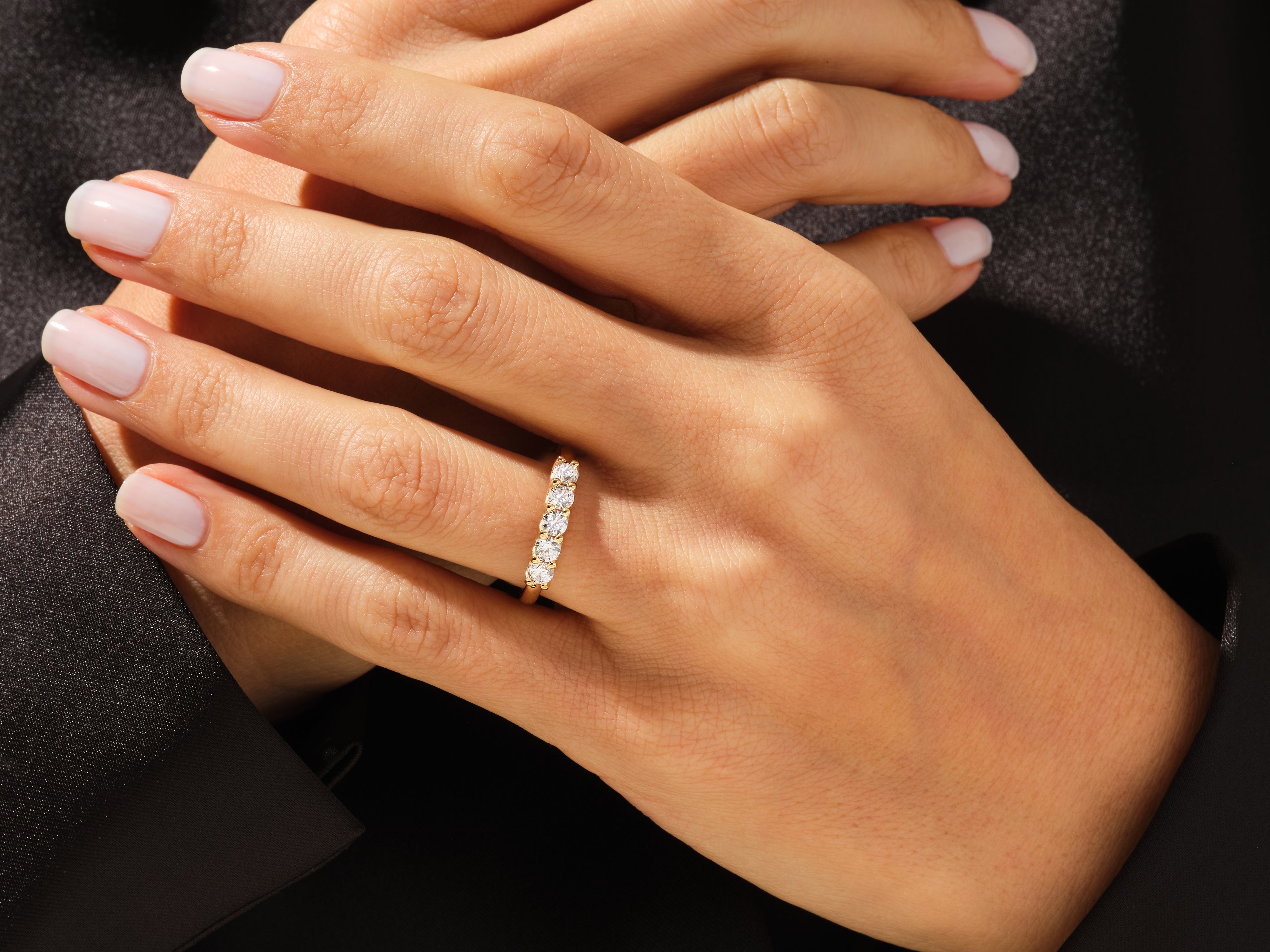 Diamond band ring on a woman's hand, fine jewelry