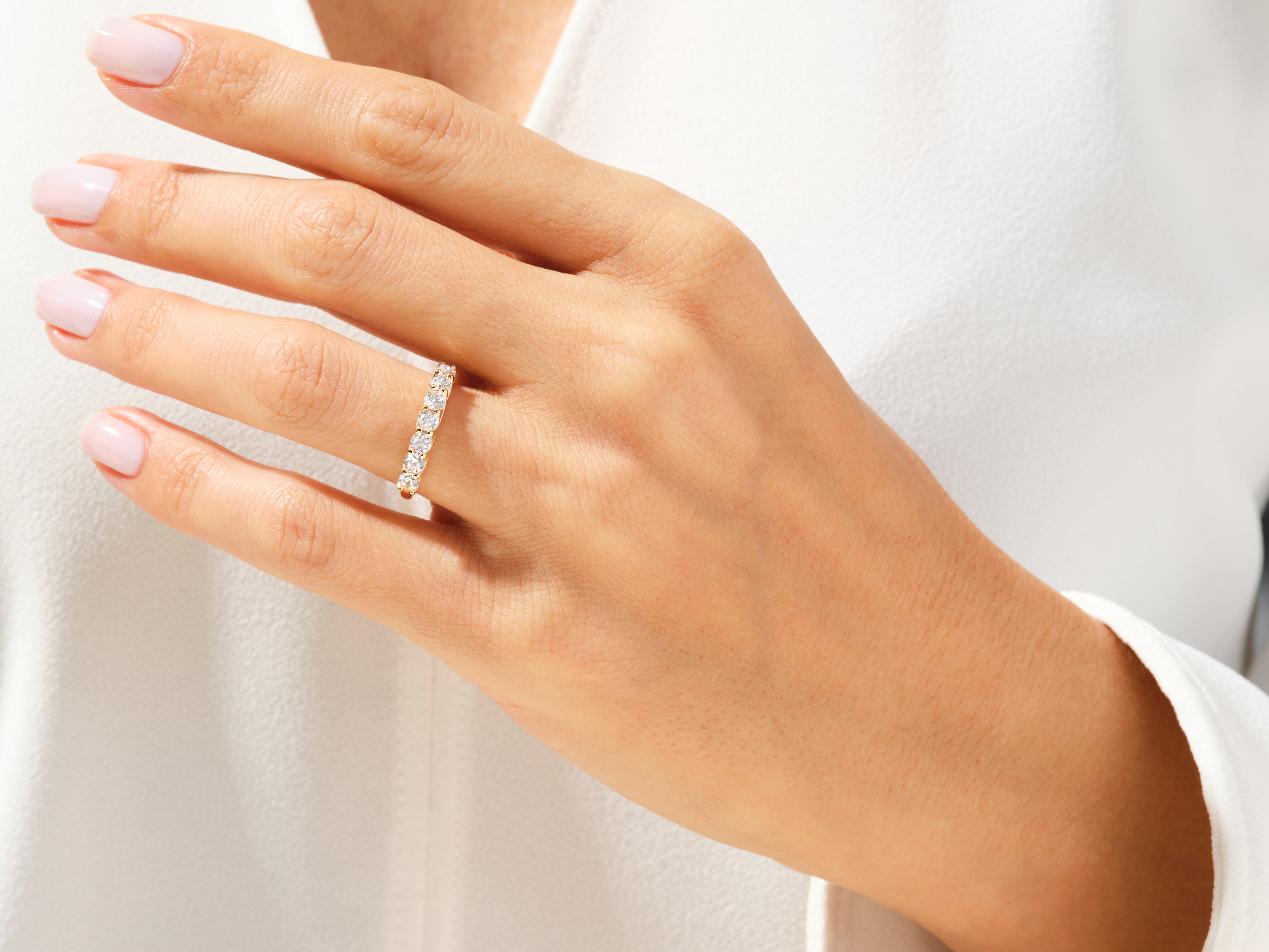 Diamond eternity ring on a woman's hand, fine jewelry