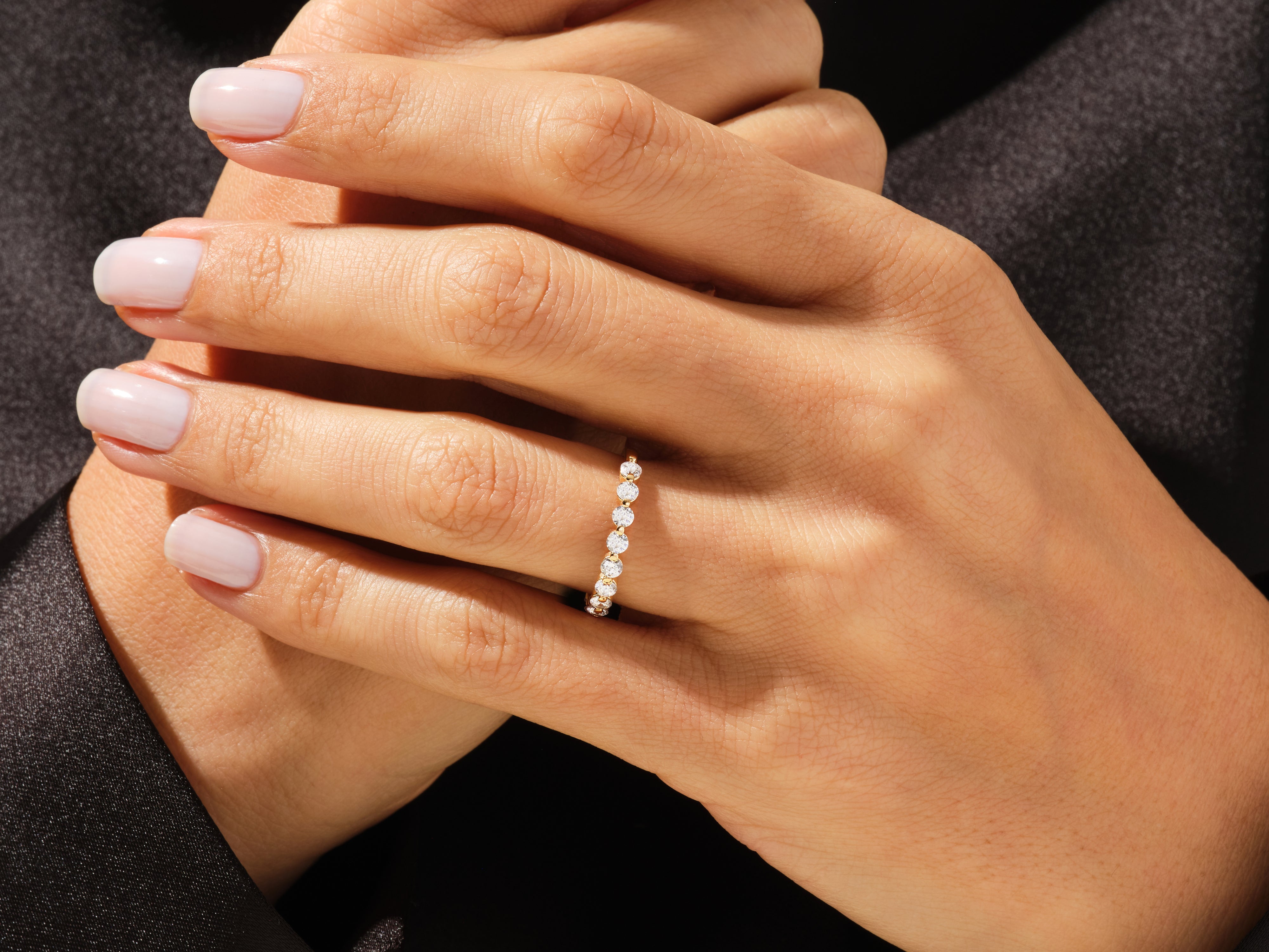 Diamond eternity ring on a woman's hand, jewelry product shot