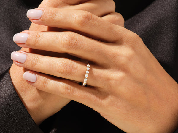 Diamond eternity ring on a woman's hand, jewelry product shot