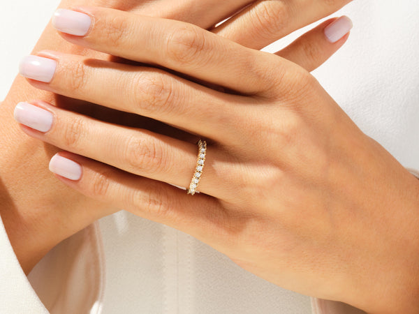 Diamond eternity ring on a woman's hand, jewelry photography