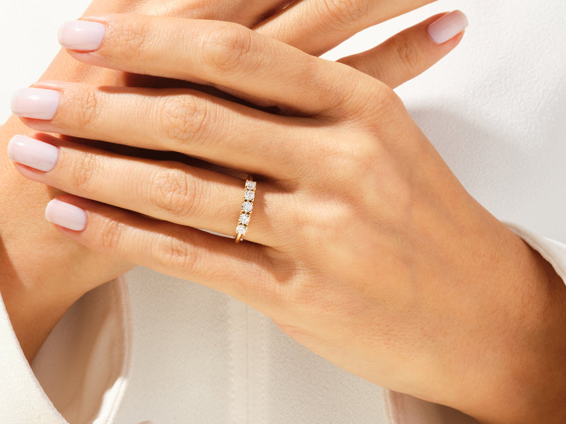 Diamond band ring on a woman's finger, jewelry product