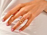 Gold stacking rings on a hand, jewelry for women