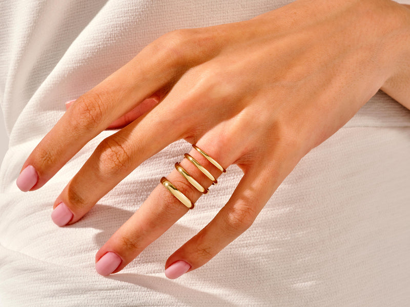 Gold stacking rings on hand, fine jewelry for women