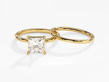 Gold engagement ring with princess cut diamond and wedding band