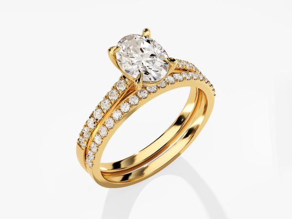 Gold oval diamond engagement ring and wedding band set