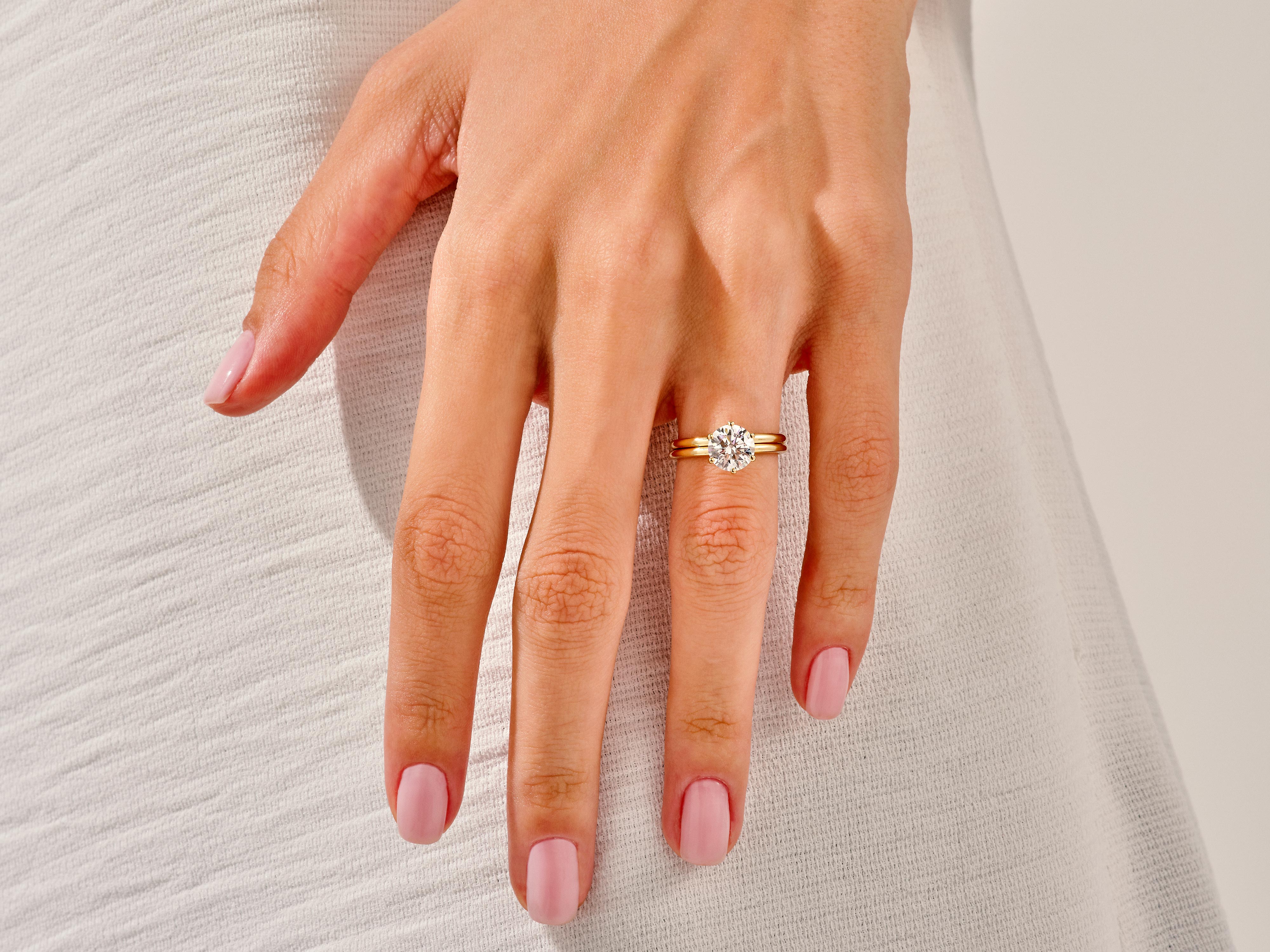 Diamond engagement ring on a hand, jewelry product photography