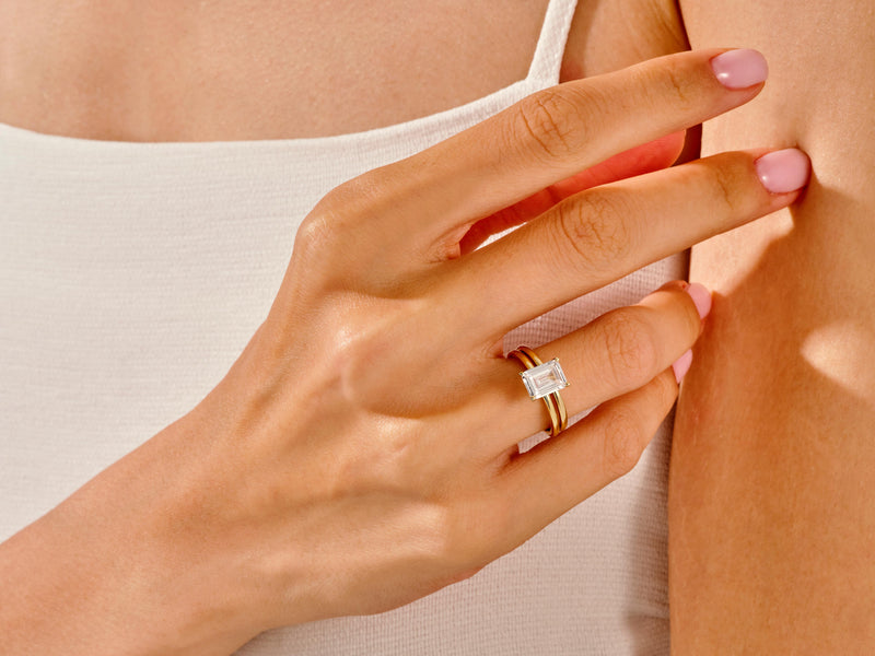 Emerald cut diamond ring on a woman's finger, fine jewelry
