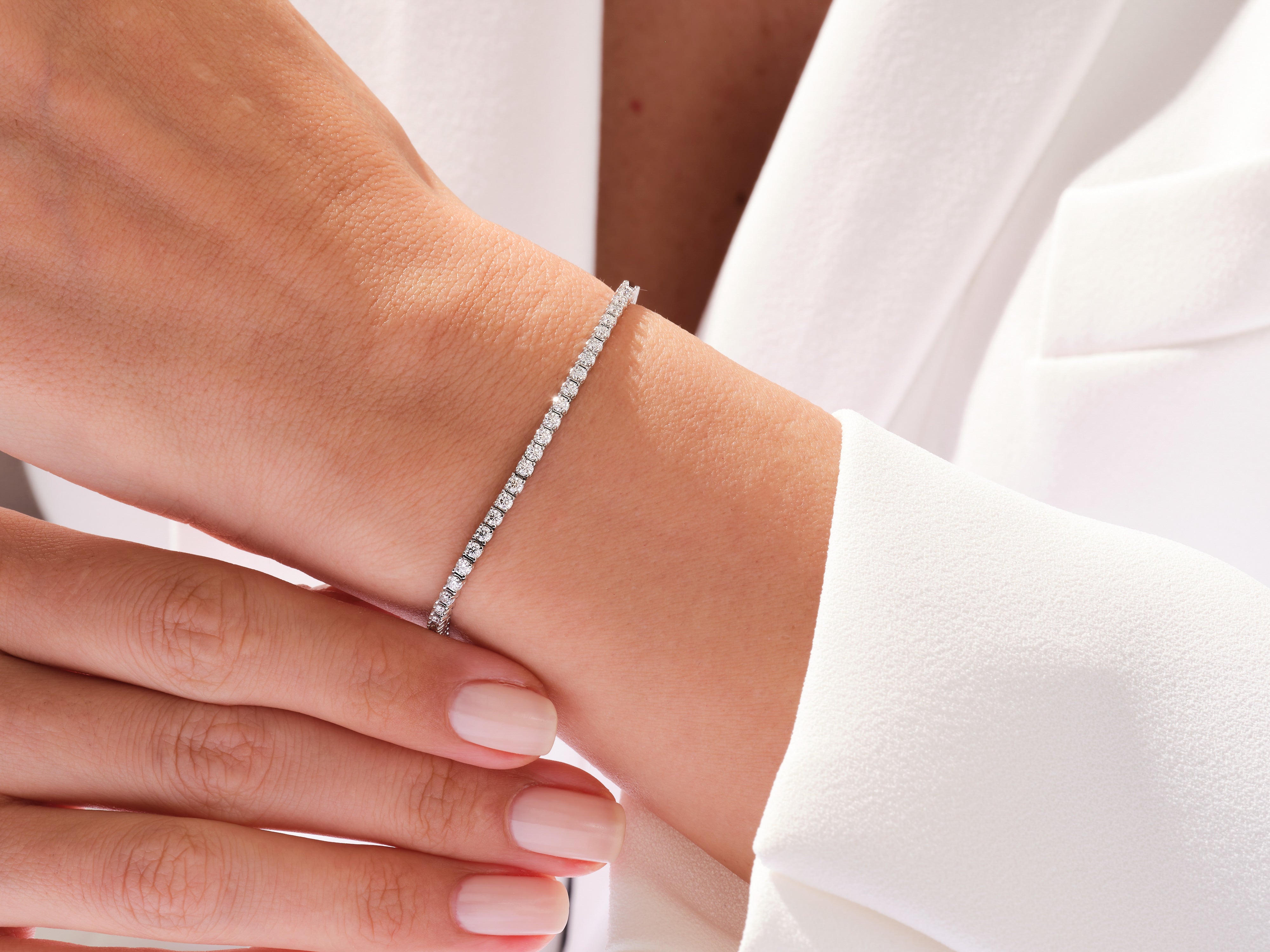 Diamond tennis bracelet on a woman's wrist, fine jewelry