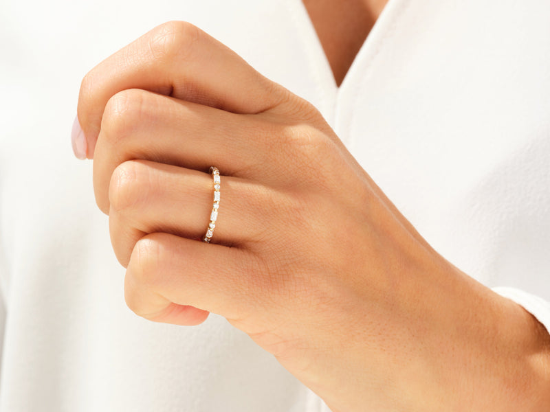 Diamond eternity ring on a hand, fine jewelry