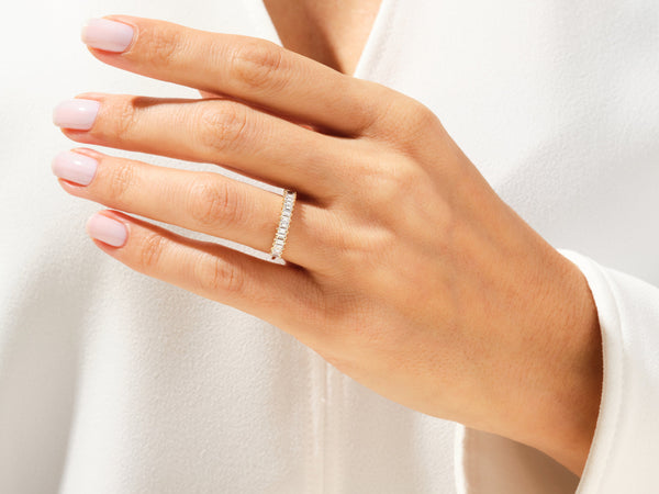 Diamond eternity band ring on a woman's finger