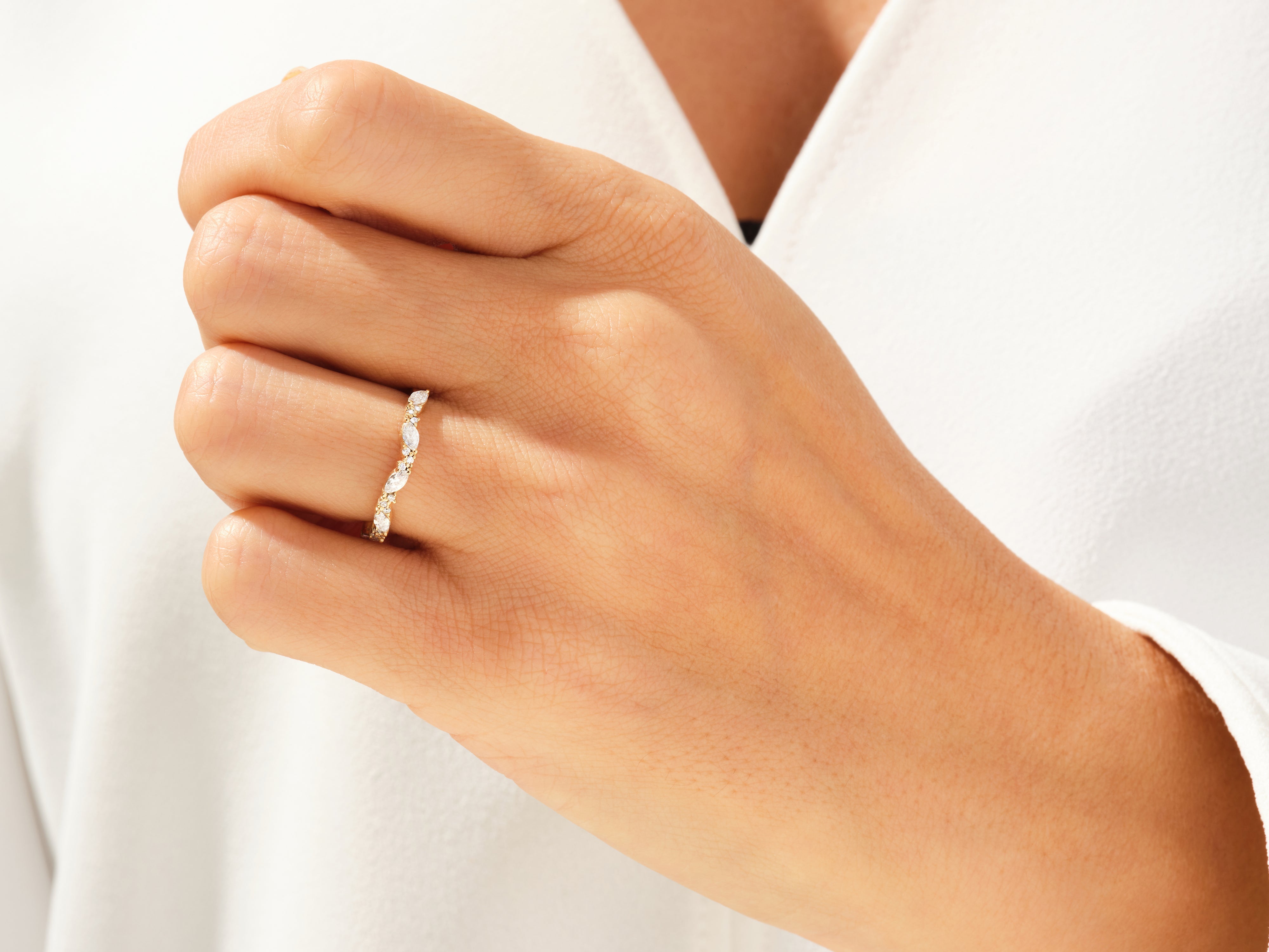 Diamond marquise band ring on a woman's finger