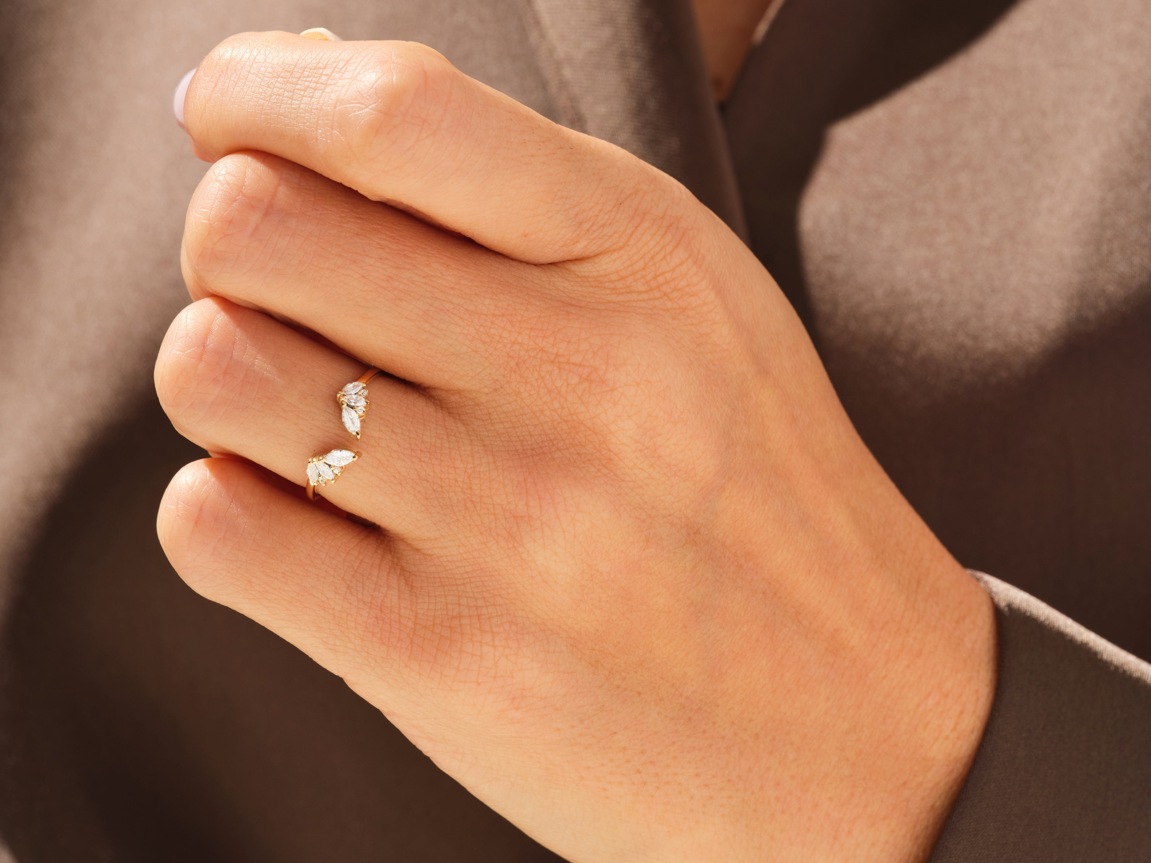 Gold ring with marquise diamonds on hand