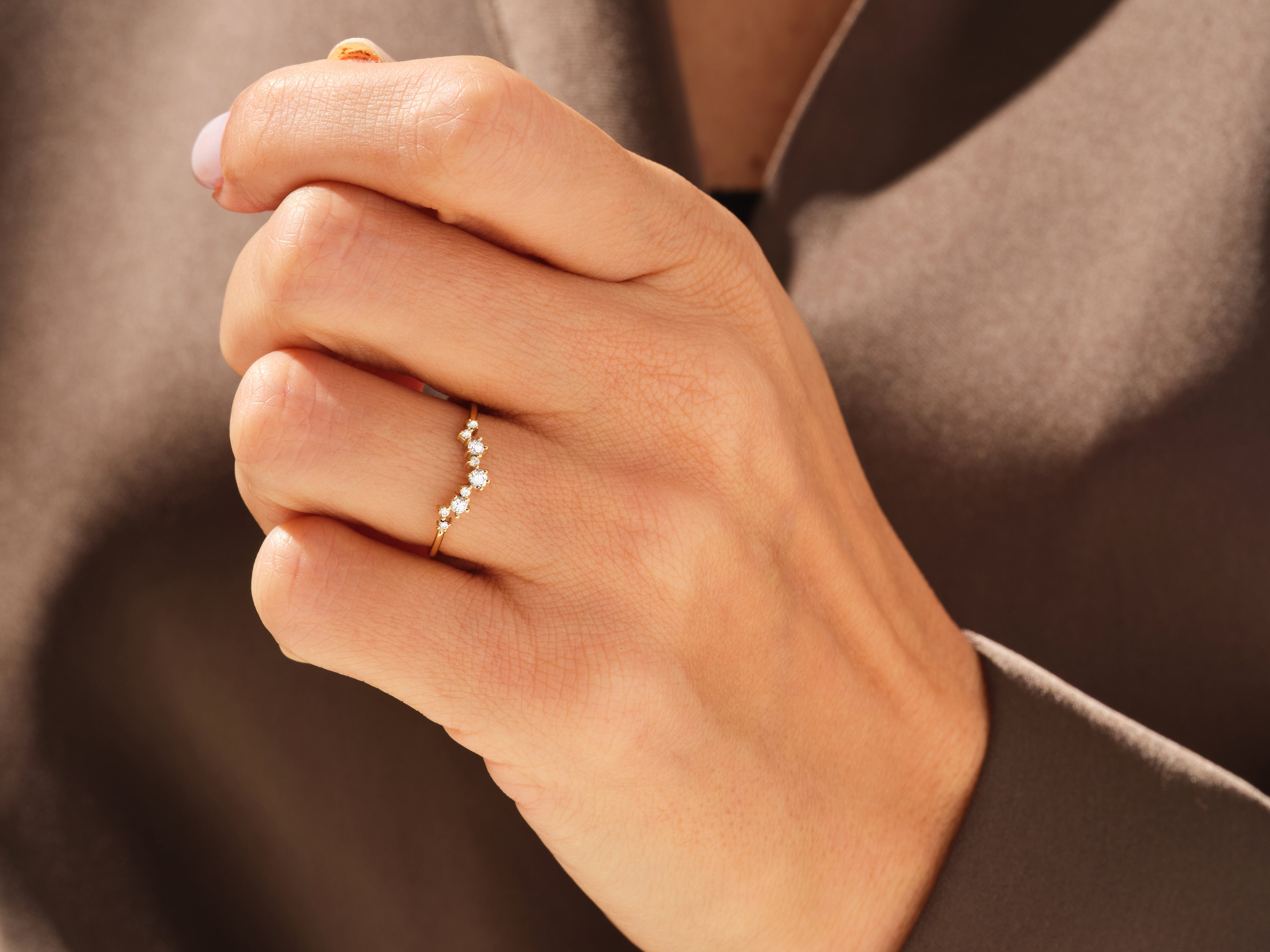 Gold diamond cluster ring on a hand