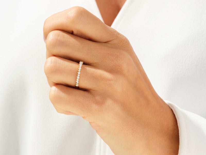 Gold diamond band ring on a woman's finger, fine jewelry