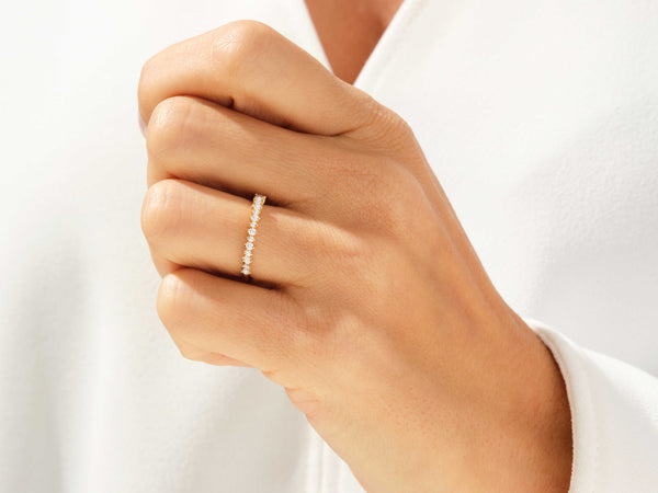 Gold diamond band ring on a woman's finger