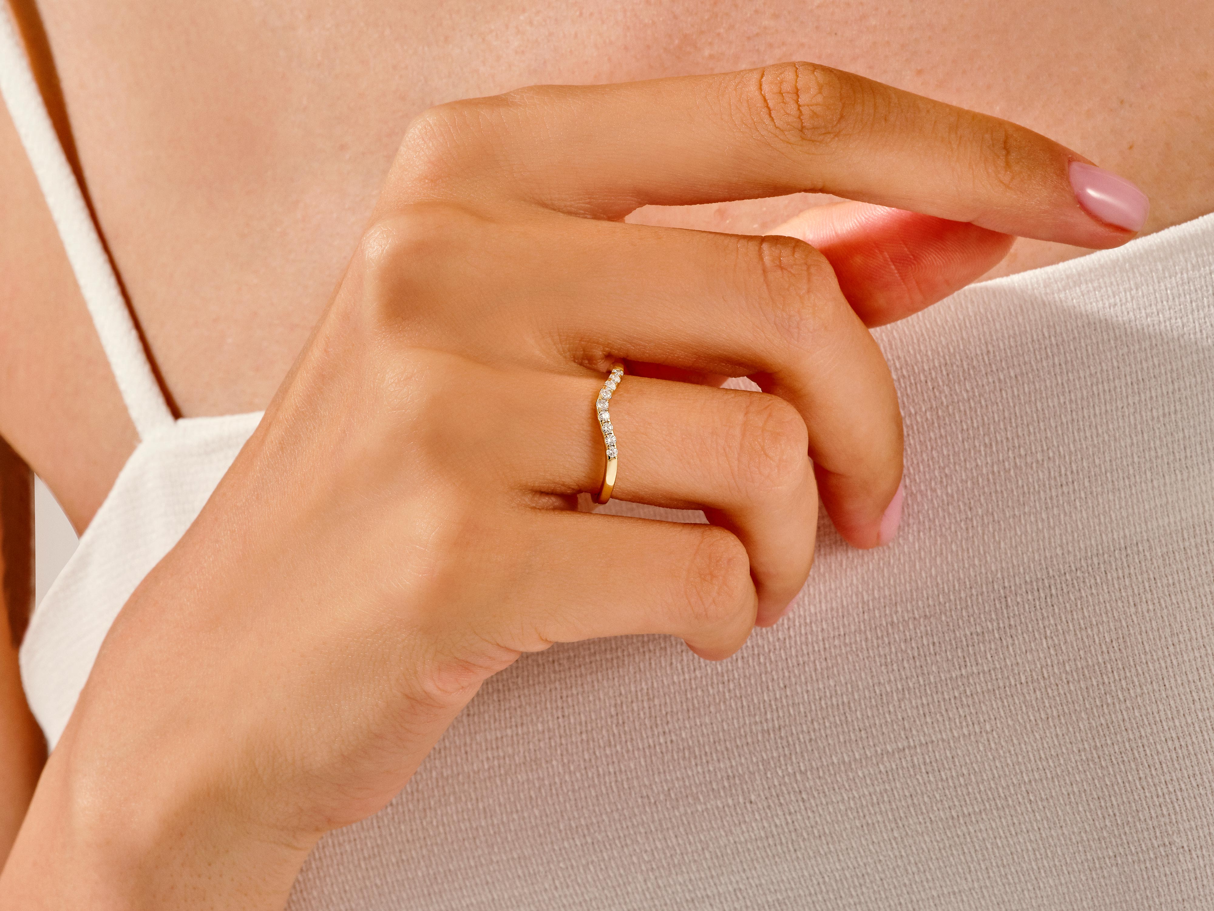 Diamond curved ring on a woman's finger, jewelry product