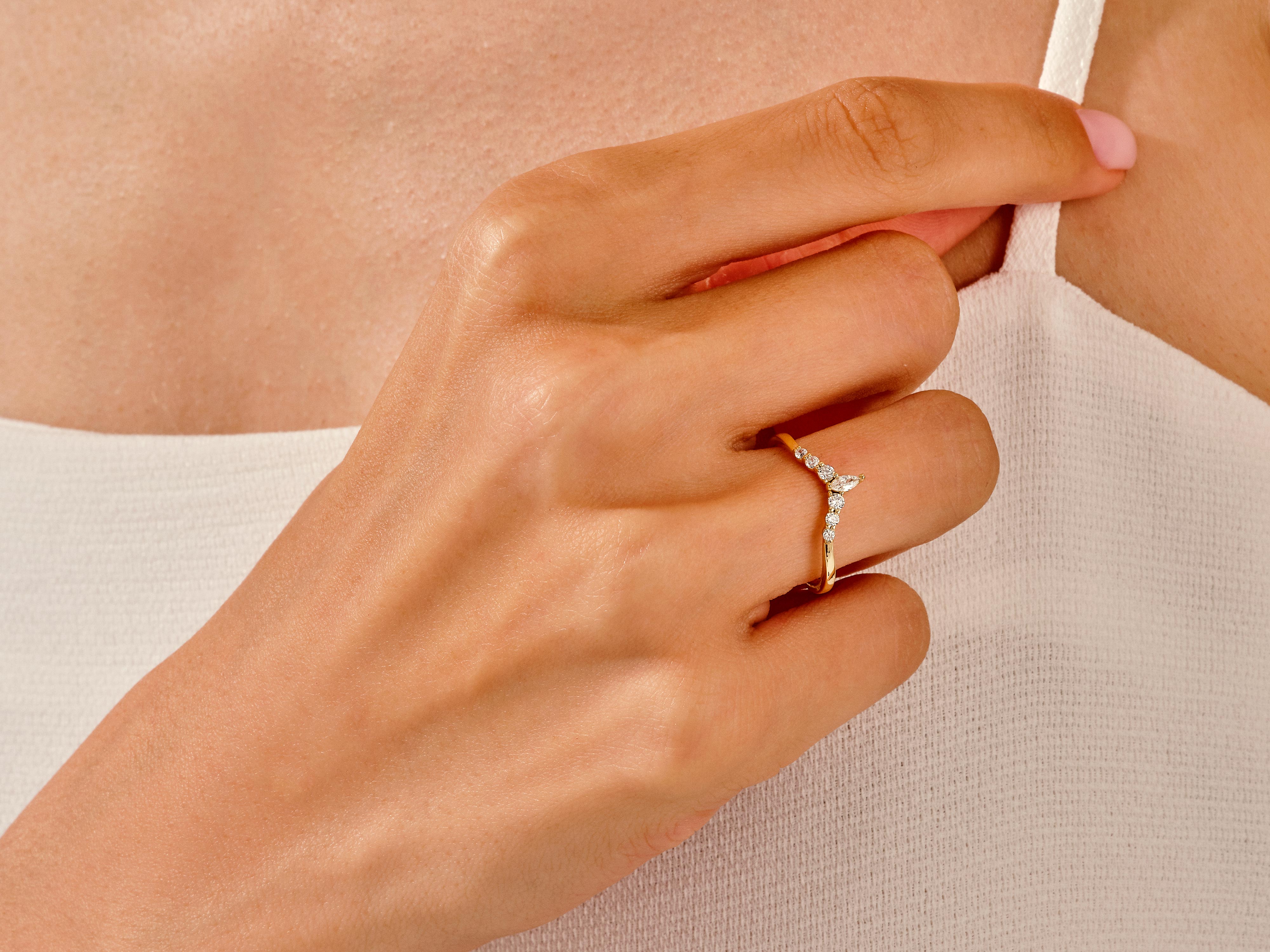 Gold diamond chevron ring on a woman's hand