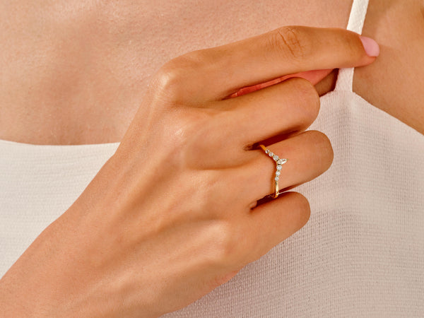 Gold diamond chevron ring on a woman's finger