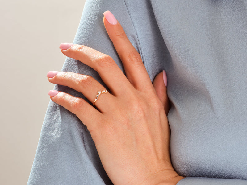Delicate gold ring with diamonds on a woman's hand