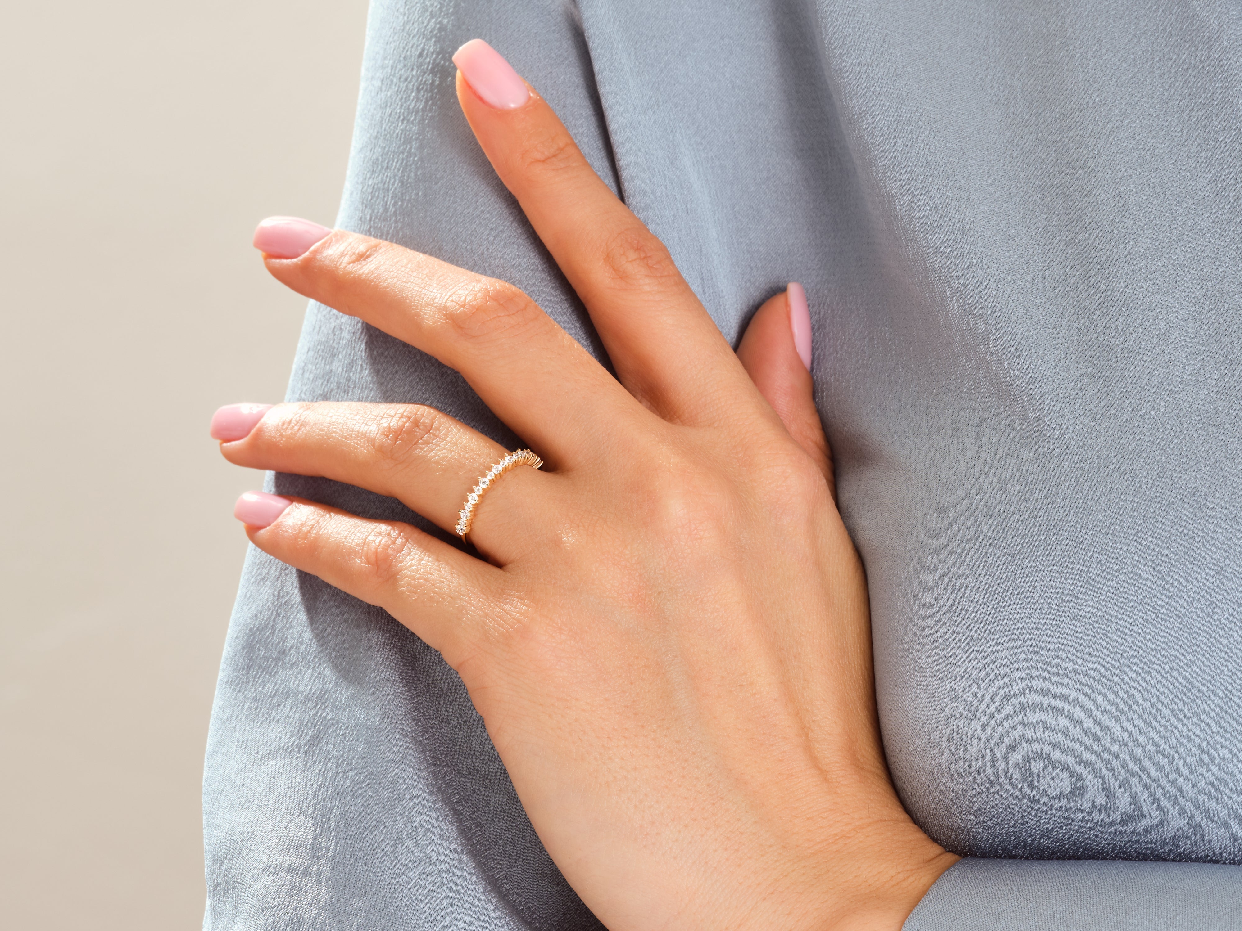 Gold diamond ring on a woman's finger, jewelry product shot