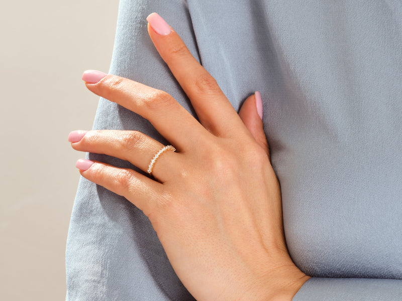 Gold diamond ring on a woman's finger, jewelry product shot