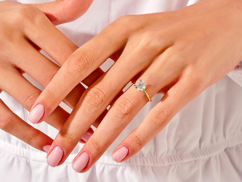 Diamond engagement ring on a woman's hand, jewelry photography