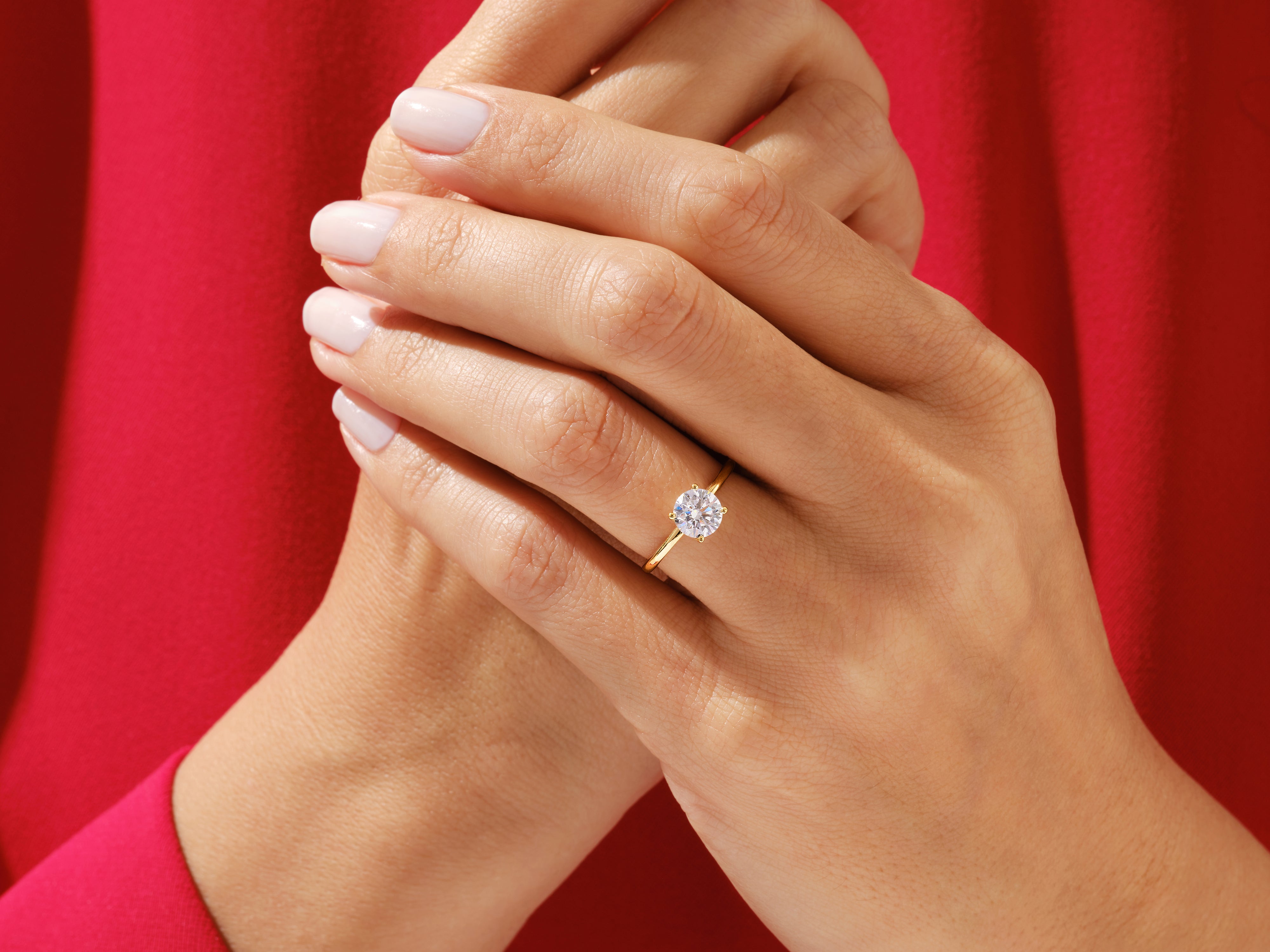 Gold diamond engagement ring on a woman's hand