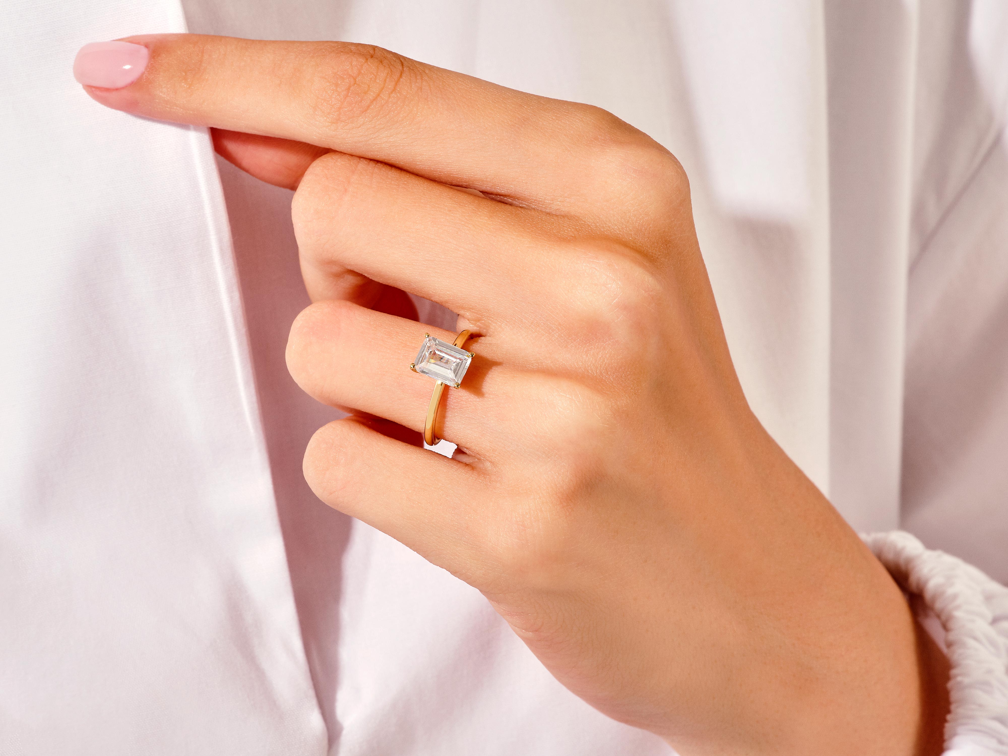 Emerald cut diamond ring on a woman's finger