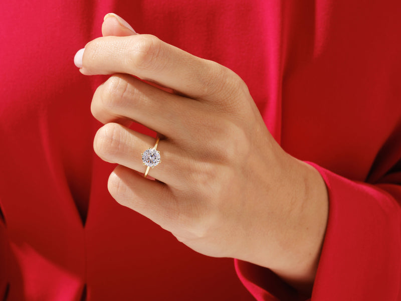 Diamond engagement ring on a hand, jewelry for her