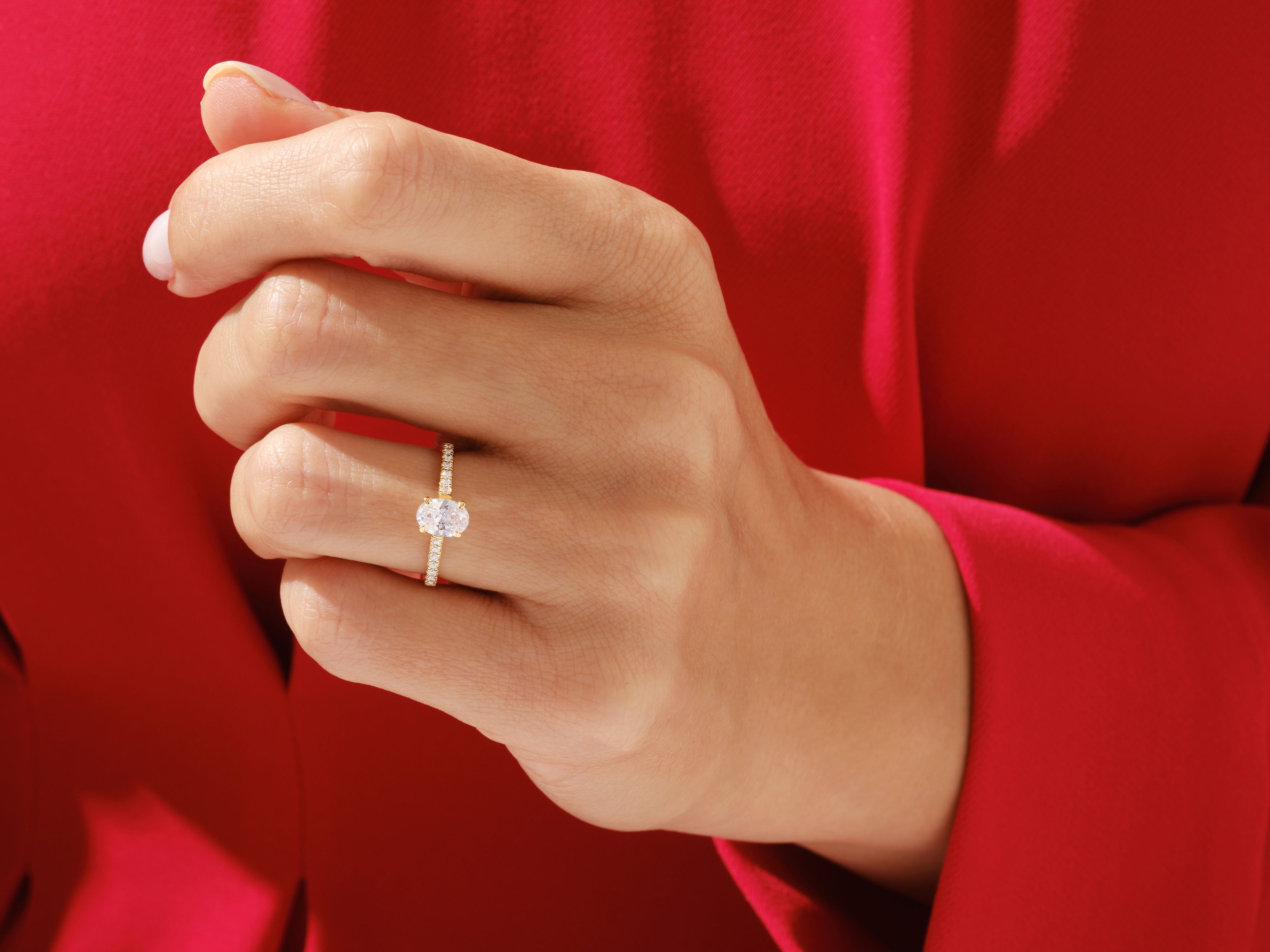 Oval diamond engagement ring on a hand, jewelry