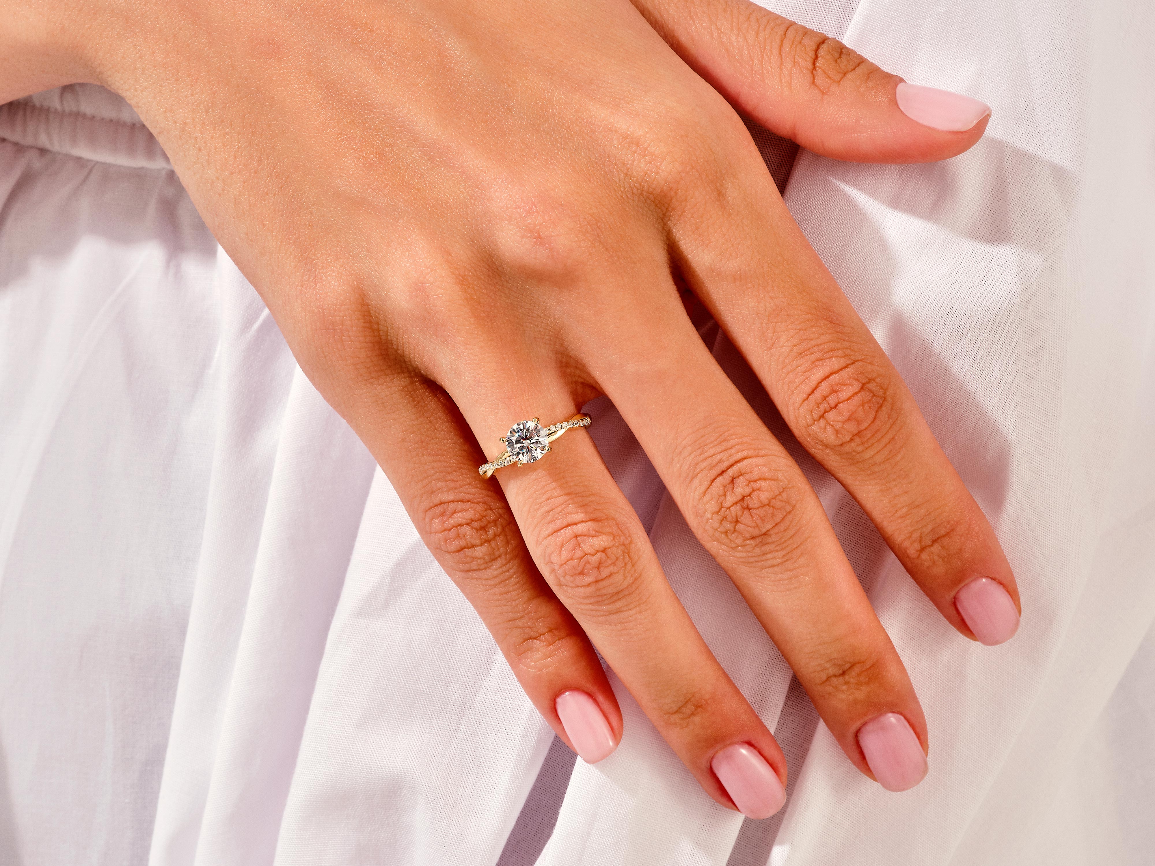 Diamond engagement ring on a woman's hand, jewelry product
