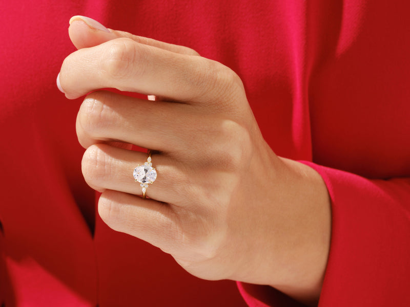 Oval diamond engagement ring on hand, luxury jewelry