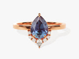 Pear-shaped alexandrite ring with diamond accents on rose gold band