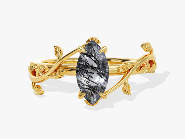Gold ring with marquise cut rutilated quartz and leaf design