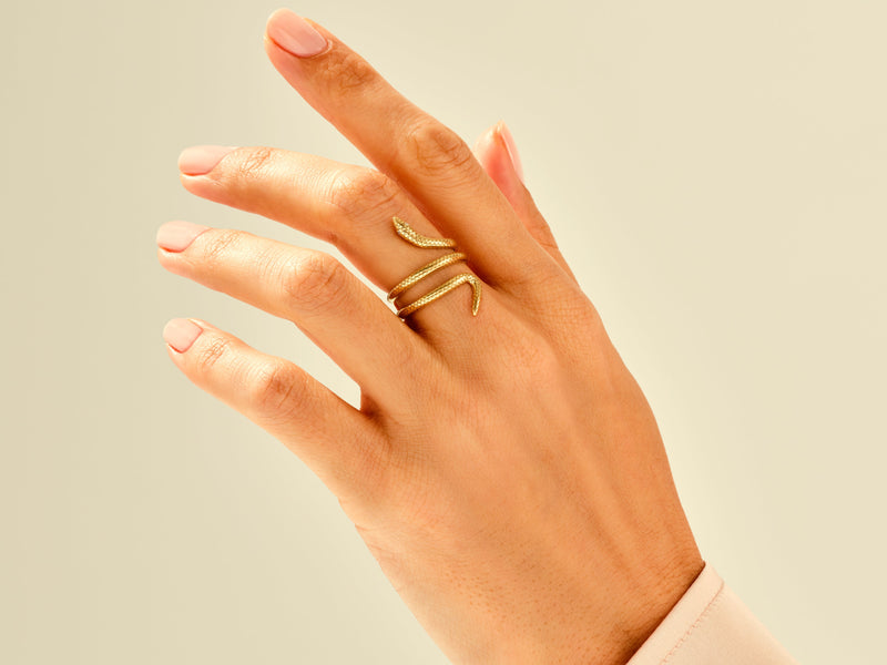 Gold snake ring on a hand, fine jewelry for women