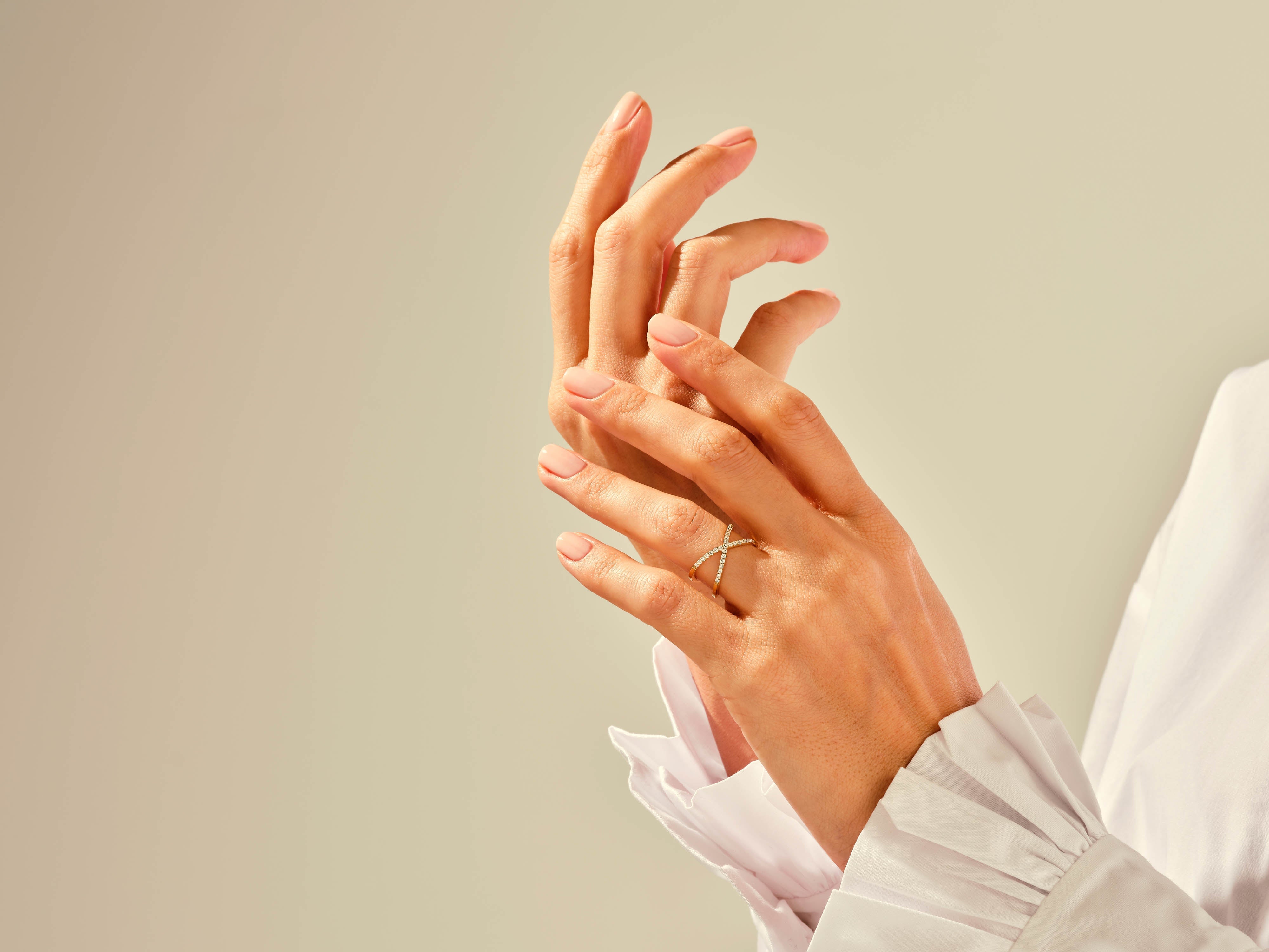 Diamond criss-cross ring on elegant hand, fine jewelry