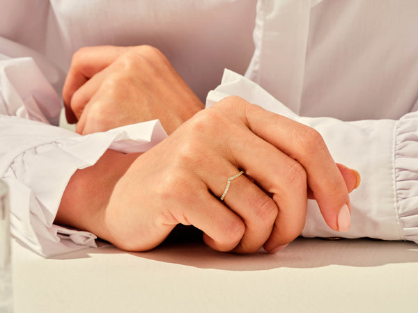 Diamond chevron ring on hand, jewelry photography