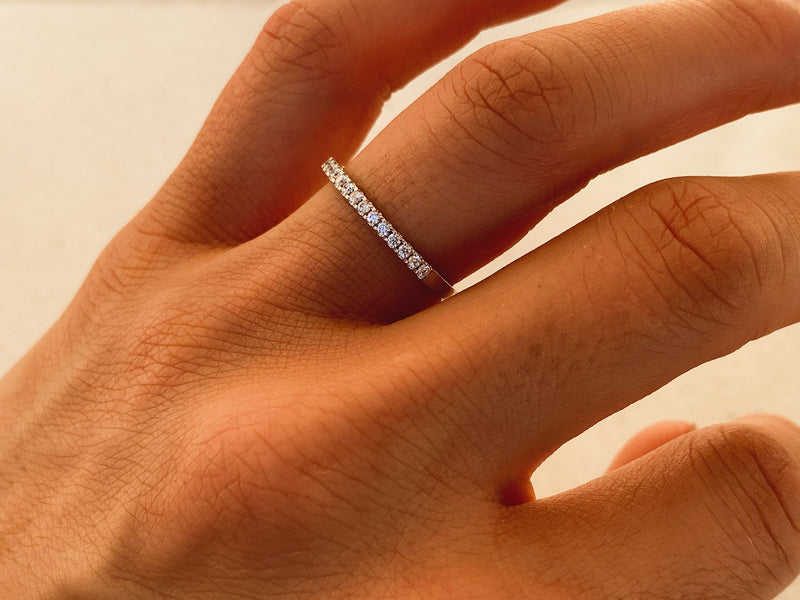 Diamond eternity band on a finger, fine jewelry for her