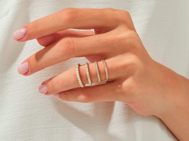 Diamond eternity rings on a hand, jewelry collection