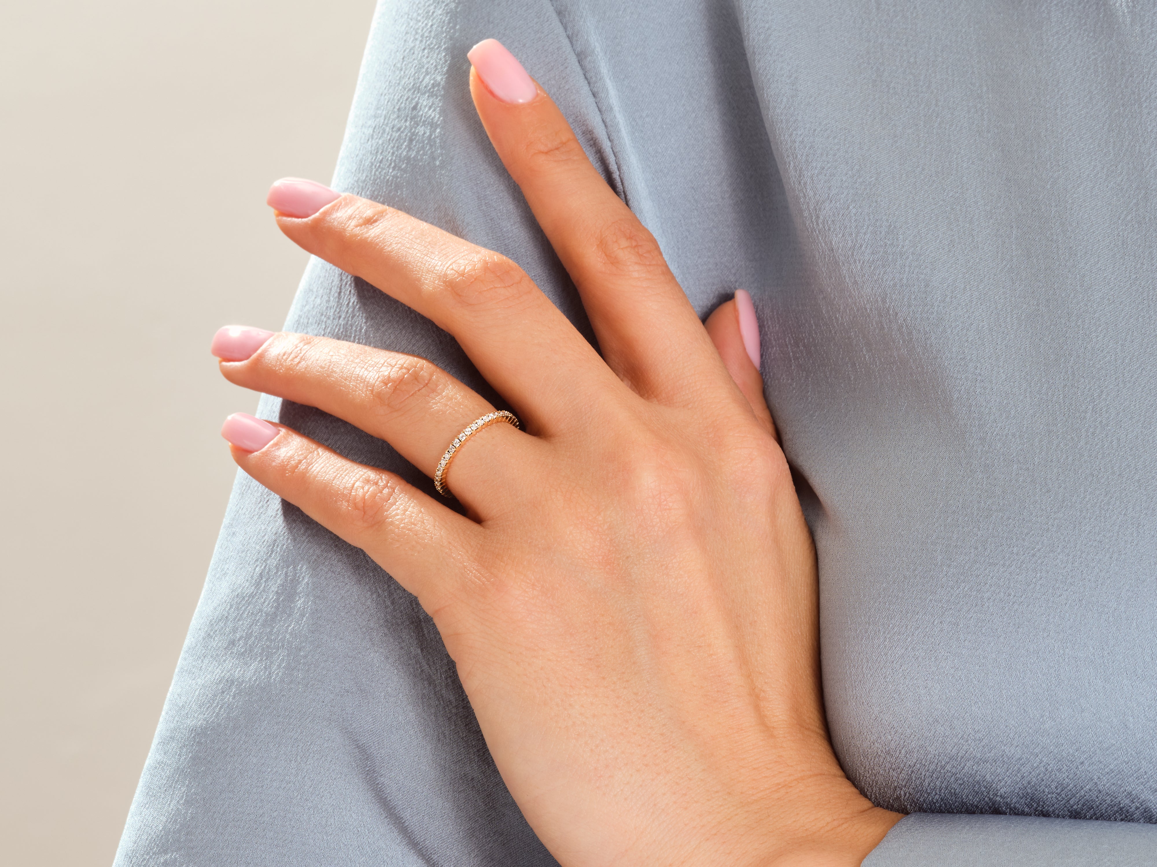 Diamond eternity band on a woman's hand, fine jewelry